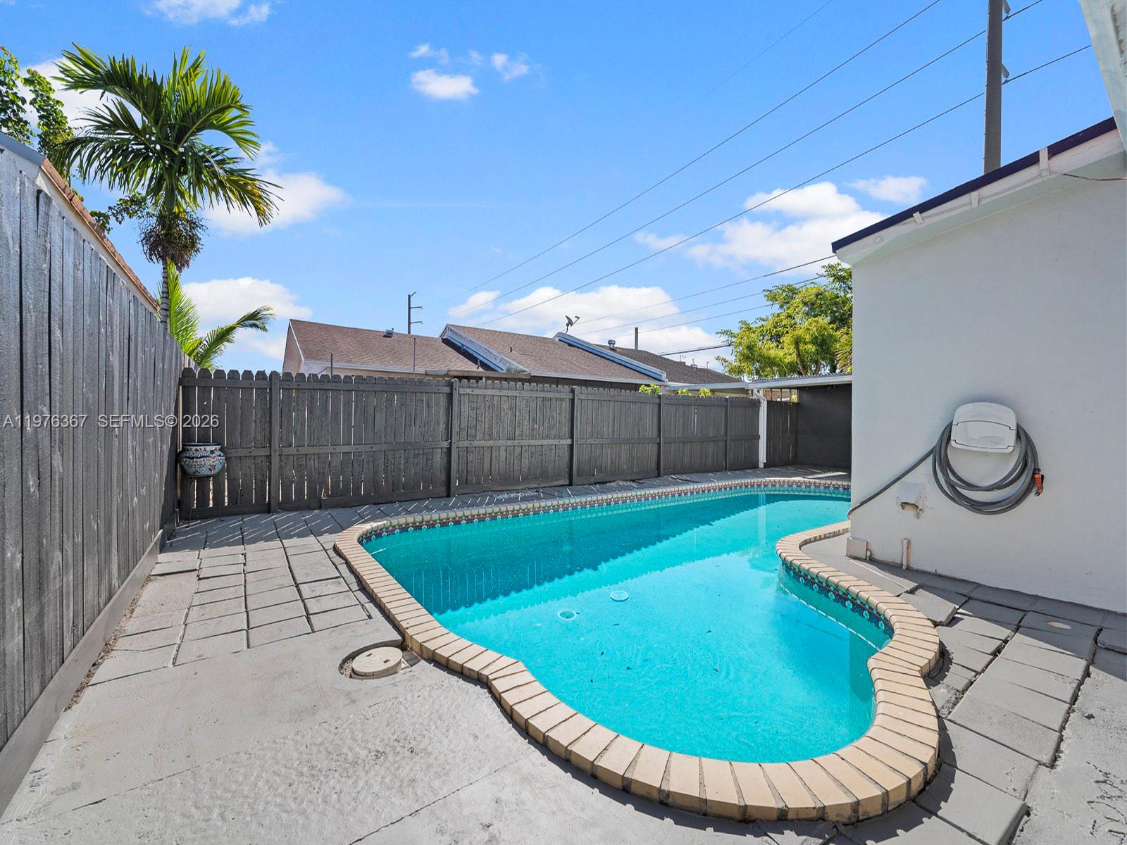 7121 Southwest 102nd Court Miami, FL 33173 - Photo 27 of 33 a view of a swimming pool with a lounge chairs