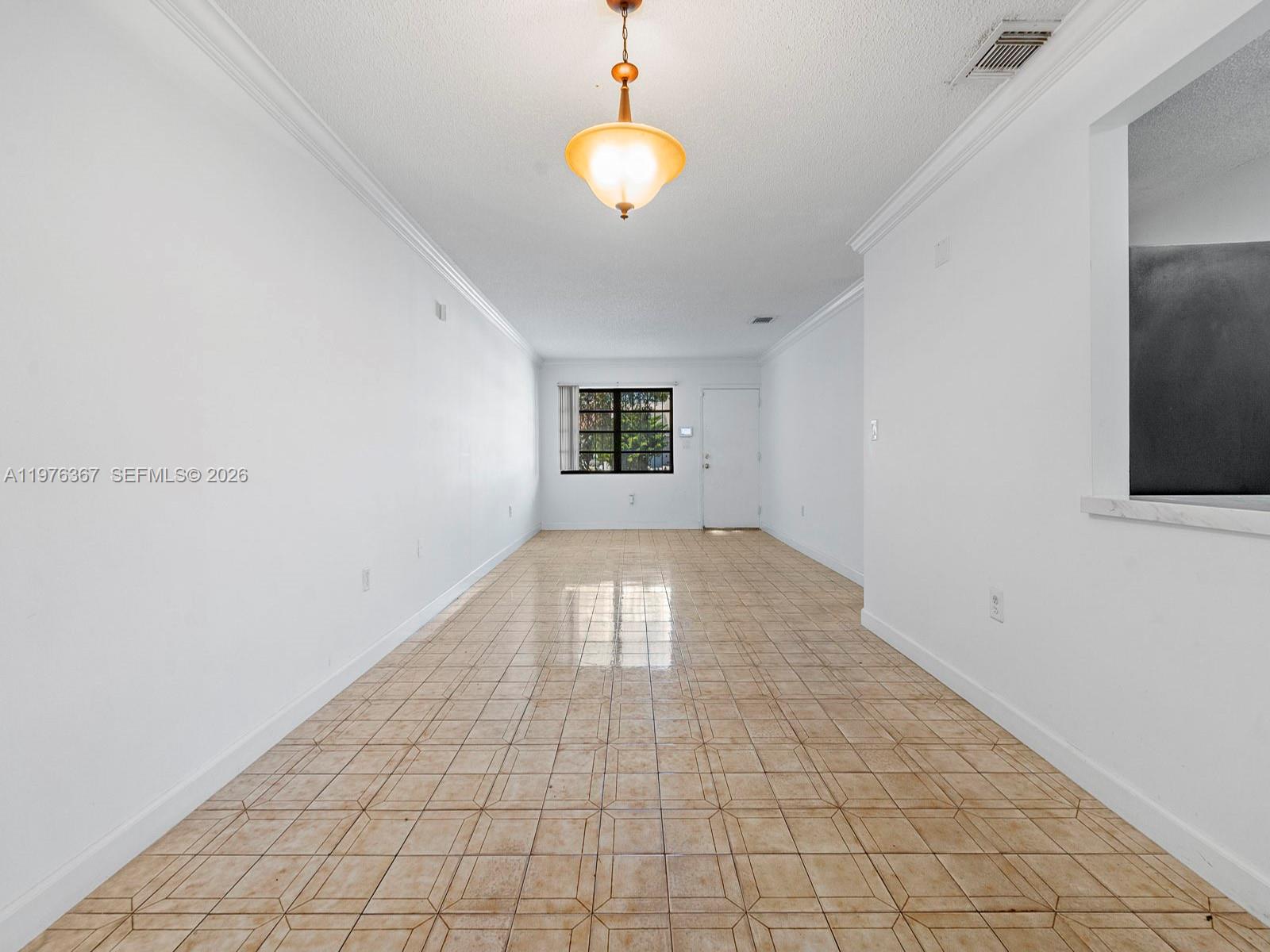 7121 Southwest 102nd Court Miami, FL 33173 - Photo 5 of 33 wooden floor in an empty room with a window