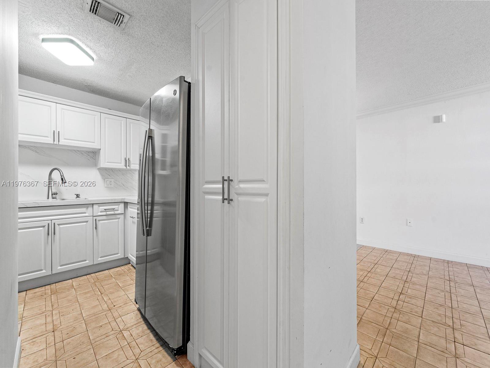 7121 Southwest 102nd Court Miami, FL 33173 - Photo 10 of 33 a kitchen with a sink and refrigerator