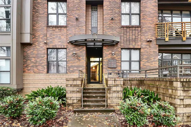 front view of a brick house with a large windows
