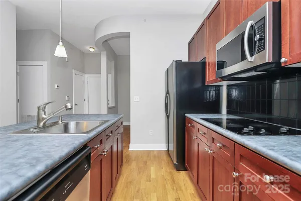 a kitchen with stainless steel appliances granite countertop a sink and a granite counter tops