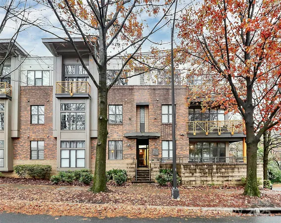 a front view of a building and trees