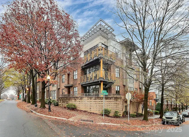 a front view of a building with trees
