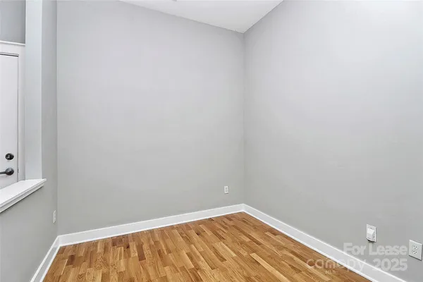 a view of a room with wooden floor and staircase