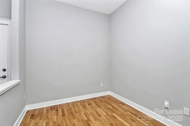 a view of a room with wooden floor and staircase