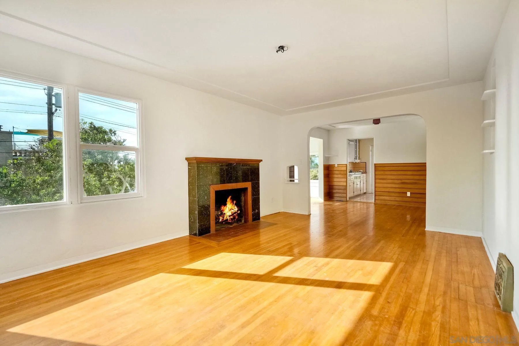4692 Niagara Avenue San Diego, CA 92107 - Photo 11 of 62 a view of empty room with wooden floor and fireplace
