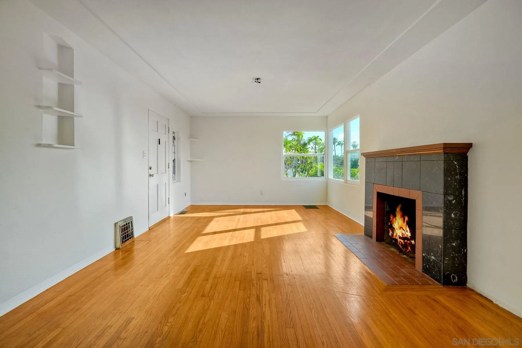 4692 Niagara Avenue San Diego, CA 92107 - Photo 13 of 62 a bedroom with a bed and a fireplace