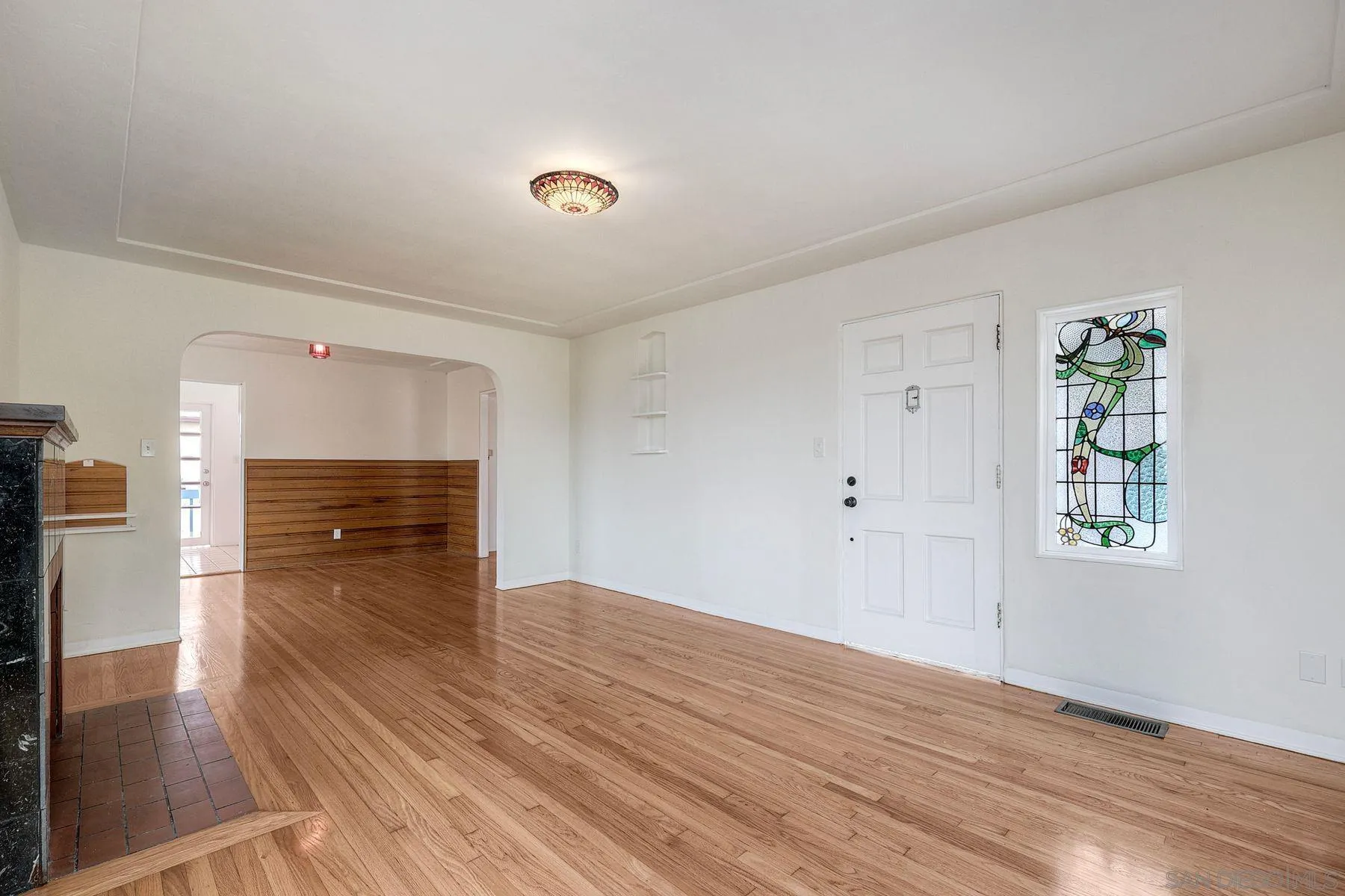 4692 Niagara Avenue San Diego, CA 92107 - Photo 14 of 62 a view of empty room with wooden floor and fireplace
