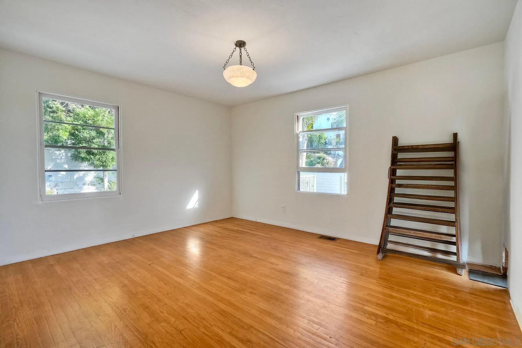 4692 Niagara Avenue San Diego, CA 92107 - Photo 16 of 62 a view of an empty room with wooden floor and a window