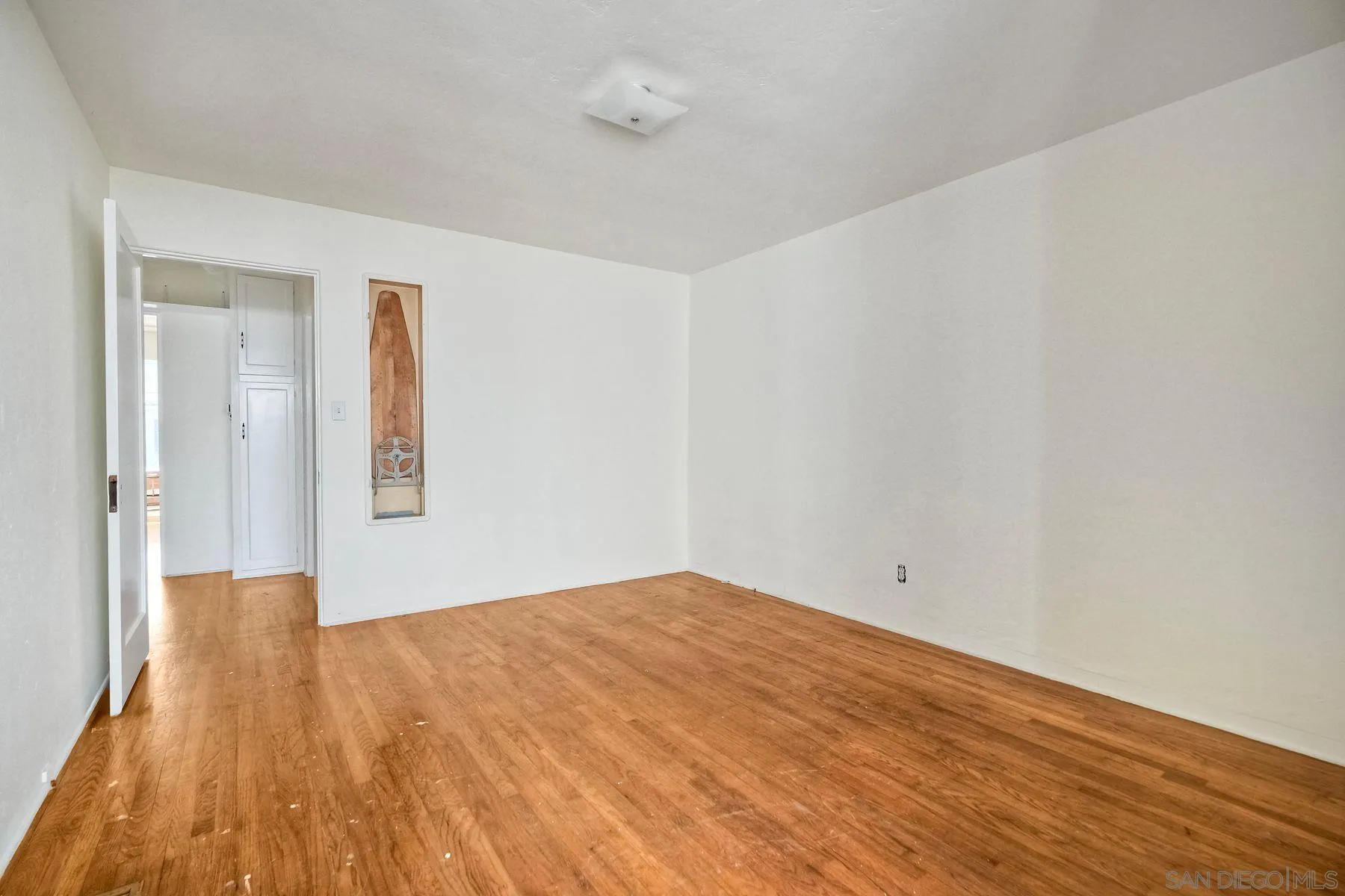 4692 Niagara Avenue San Diego, CA 92107 - Photo 17 of 62 a view of empty room with wooden floor and fan