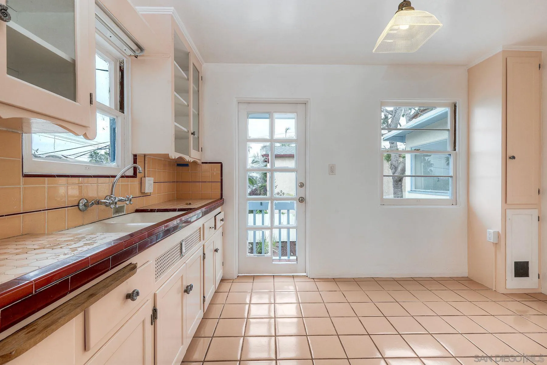 4692 Niagara Avenue San Diego, CA 92107 - Photo 19 of 62 a kitchen with granite countertop a sink stove and cabinets