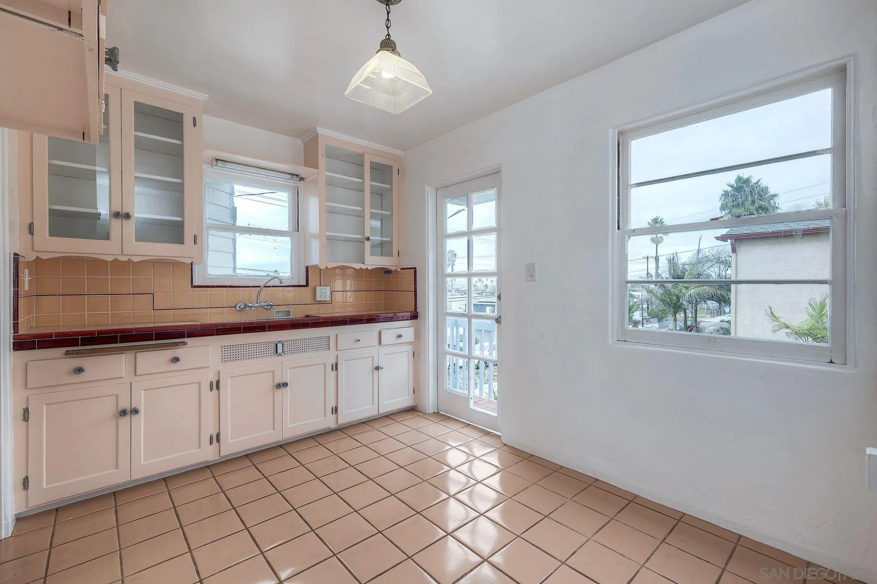 4692 Niagara Avenue San Diego, CA 92107 - Photo 20 of 62 a kitchen with granite countertop white cabinets a granite counter tops and a large window