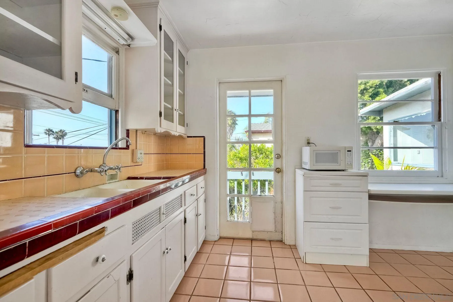 4692 Niagara Avenue San Diego, CA 92107 - Photo 24 of 62 a kitchen with a sink and cabinets