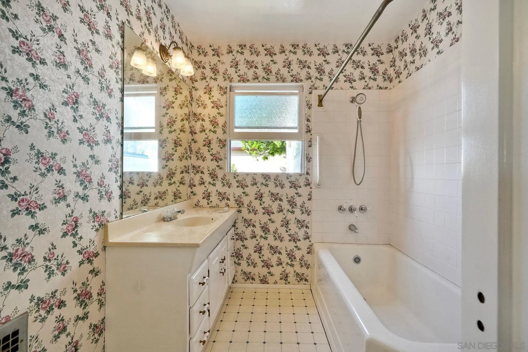 4692 Niagara Avenue San Diego, CA 92107 - Photo 25 of 62 a bathroom with a bathtub sink and mirror