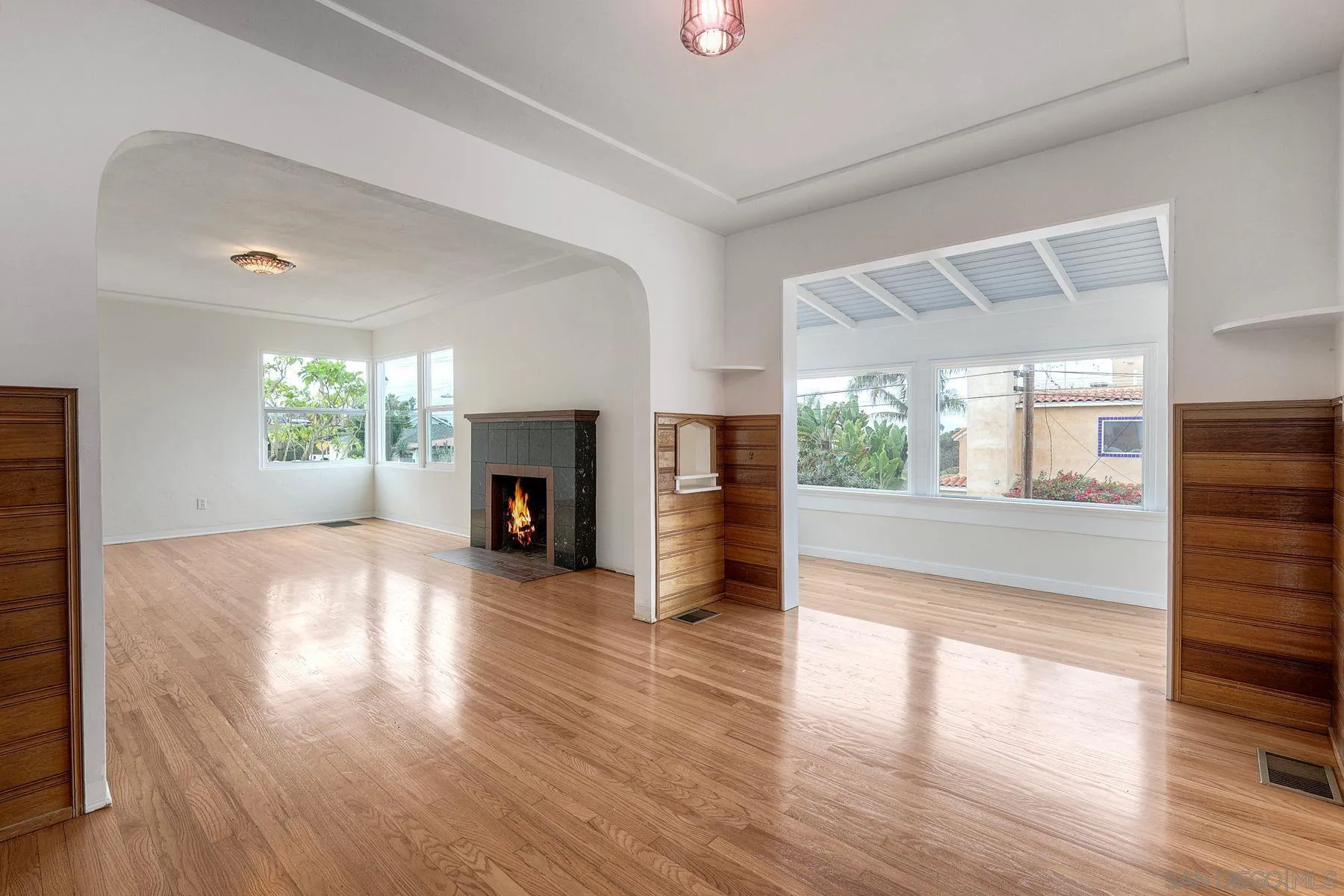 4692 Niagara Avenue San Diego, CA 92107 - Photo 46 of 62 a view of a livingroom with wooden floor and a fireplace