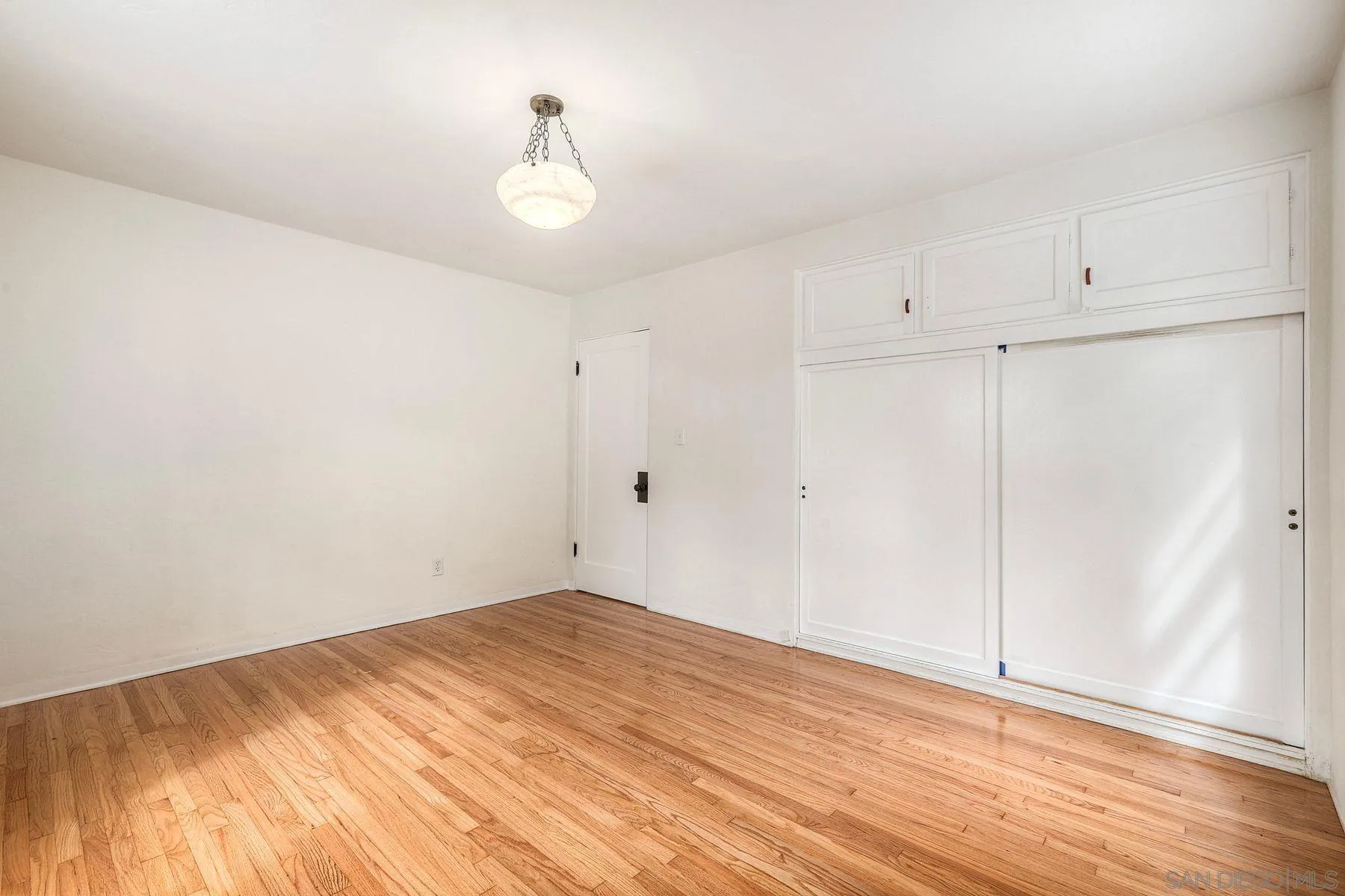 4692 Niagara Avenue San Diego, CA 92107 - Photo 49 of 62 a view of empty room with wooden floor