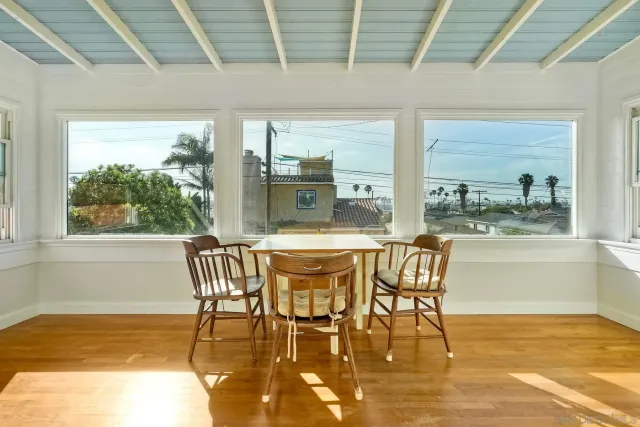 a view of an empty room with a fireplace and window