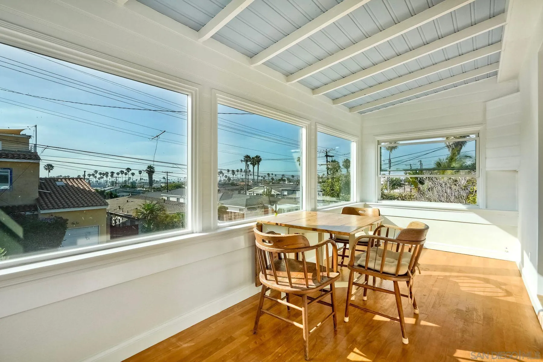 4692 Niagara Avenue San Diego, CA 92107 - Photo 6 of 62 a dining room with furniture wooden floor and a rug