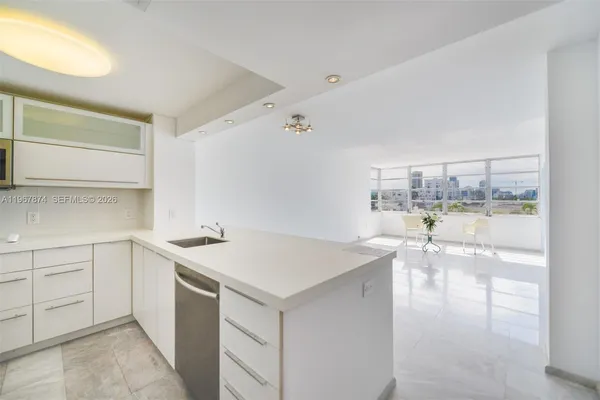 a kitchen that has a sink and a stove in it