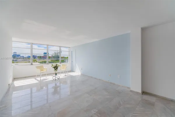 a view of a dining room with a table and chairs