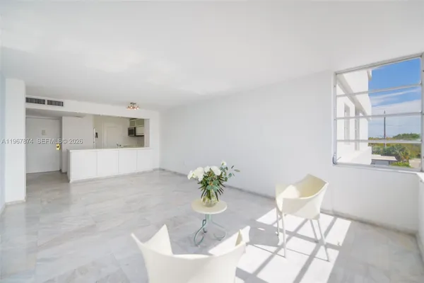 a living room with furniture and white walls