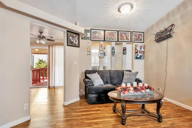 a living room with furniture and a wooden floor