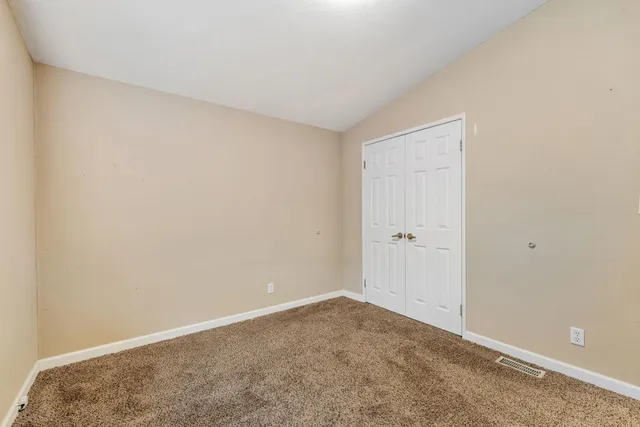 a bathroom with a granite countertop sink mirror and toilet