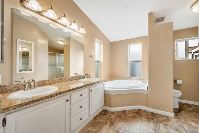 a bathroom with a tub sink and mirror