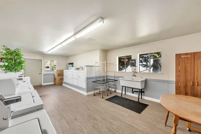 a kitchen with white cabinets and white appliances