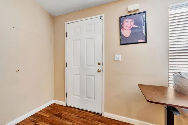 a view of a room with wooden floor