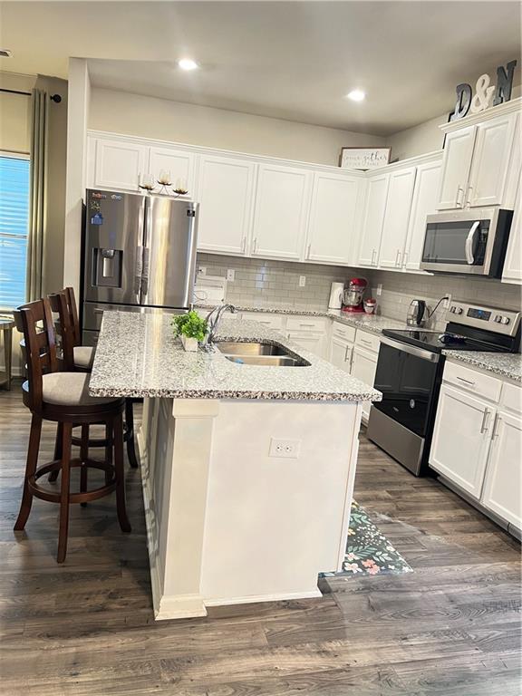1775 Labonte Parkway McDonough, GA 30253 - Photo 12 of 20 a kitchen with refrigerator cabinets and wooden floor