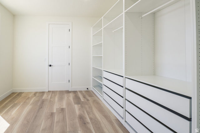 3322 250 S Street Vernal, UT 84078 - Photo 17 of 37 Custom closet system featuring extensive shelving, multiple hanging rods, and integrated drawers with dark hardware