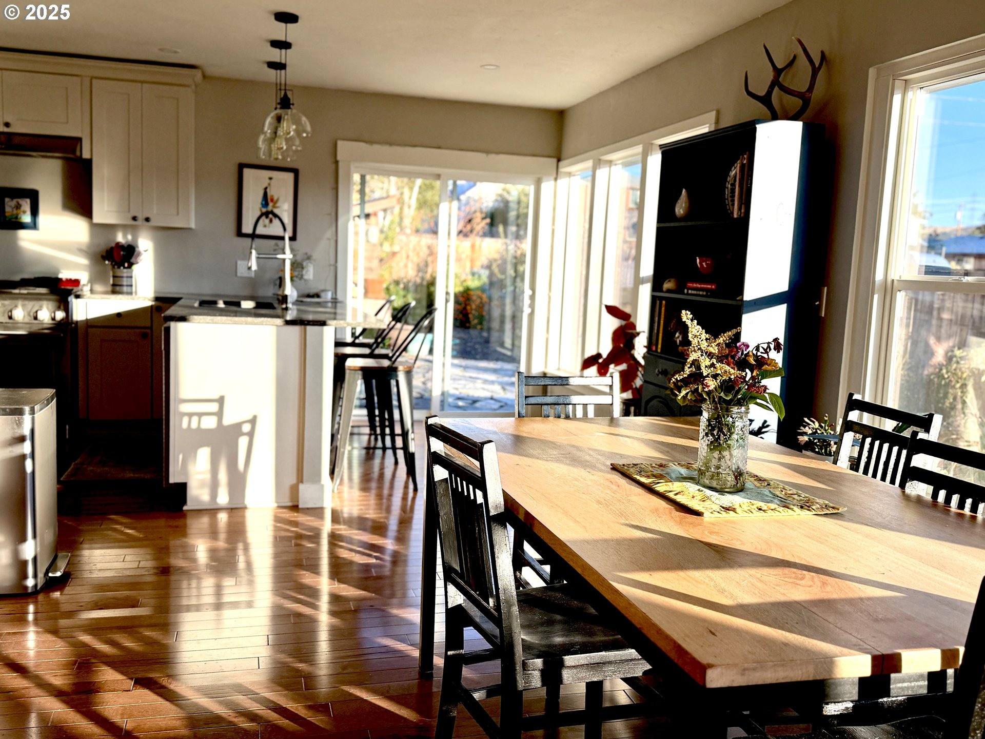 201 4th Street Maupin, OR 97037 - Photo 4 of 24 a kitchen with a table chairs and a refrigerator