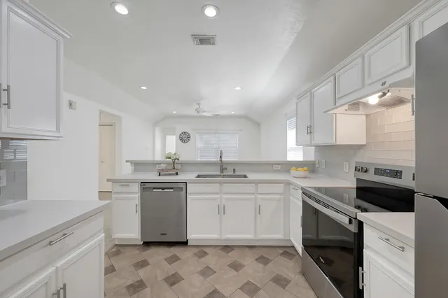 a kitchen with a sink stove and cabinets