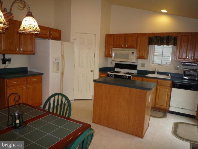 1749 Canal Run Drive Point of Rocks, MD 21777 - Photo 3 of 21 a kitchen with stainless steel appliances a stove a sink a refrigerator wooden floor and cabinets
