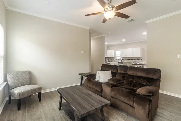 a living room with furniture and a chair