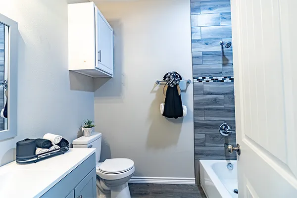 a bathroom with a granite countertop toilet a sink and a bathtub