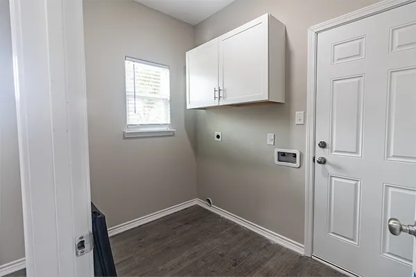 an empty room with wooden floor and closet