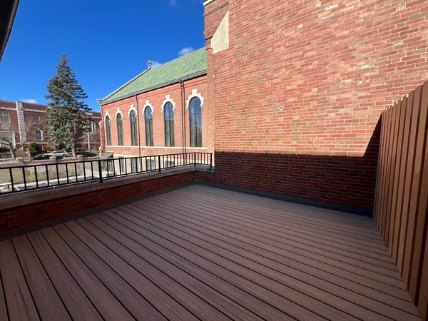 a view of balcony with wooden floor