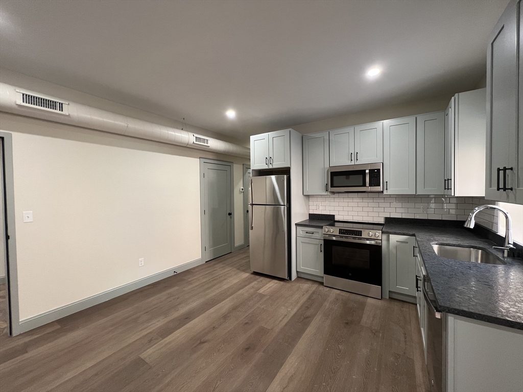 160 Seabury Street, Unit 10 Fall River, MA 02720 - Photo 5 of 11 a kitchen with stainless steel appliances granite countertop a refrigerator sink and stove