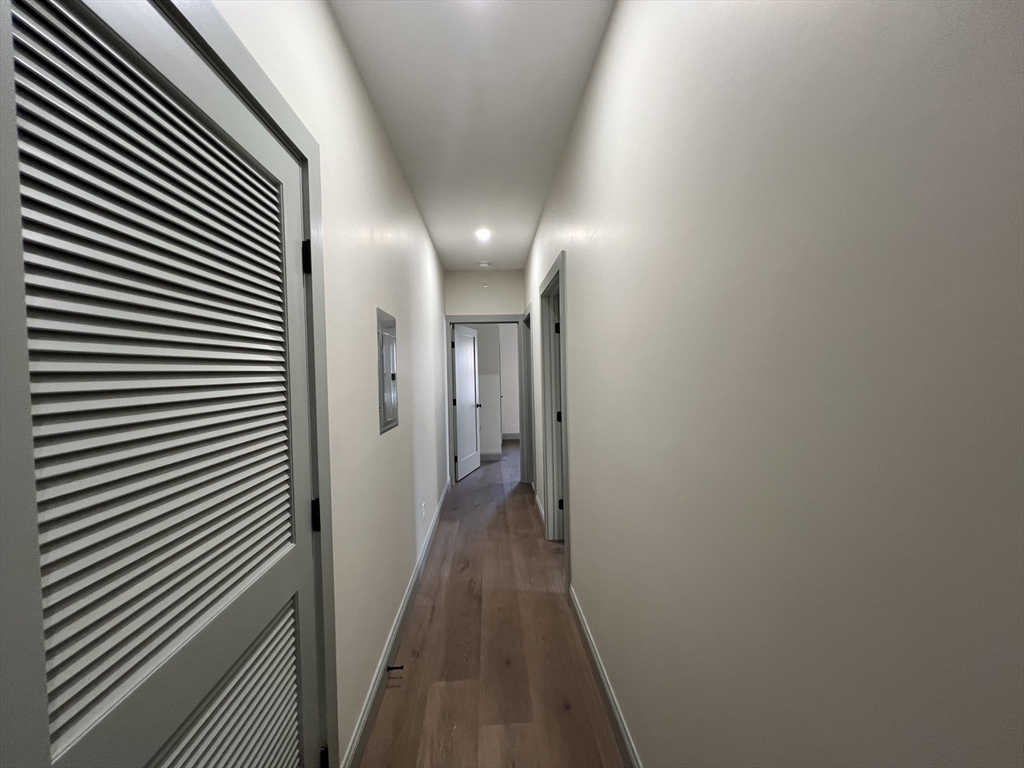 160 Seabury Street, Unit 10 Fall River, MA 02720 - Photo 6 of 11 a view of a hallway with wooden floor