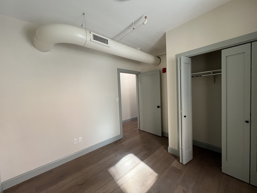 160 Seabury Street, Unit 10 Fall River, MA 02720 - Photo 7 of 11 a view of empty room with wooden floor