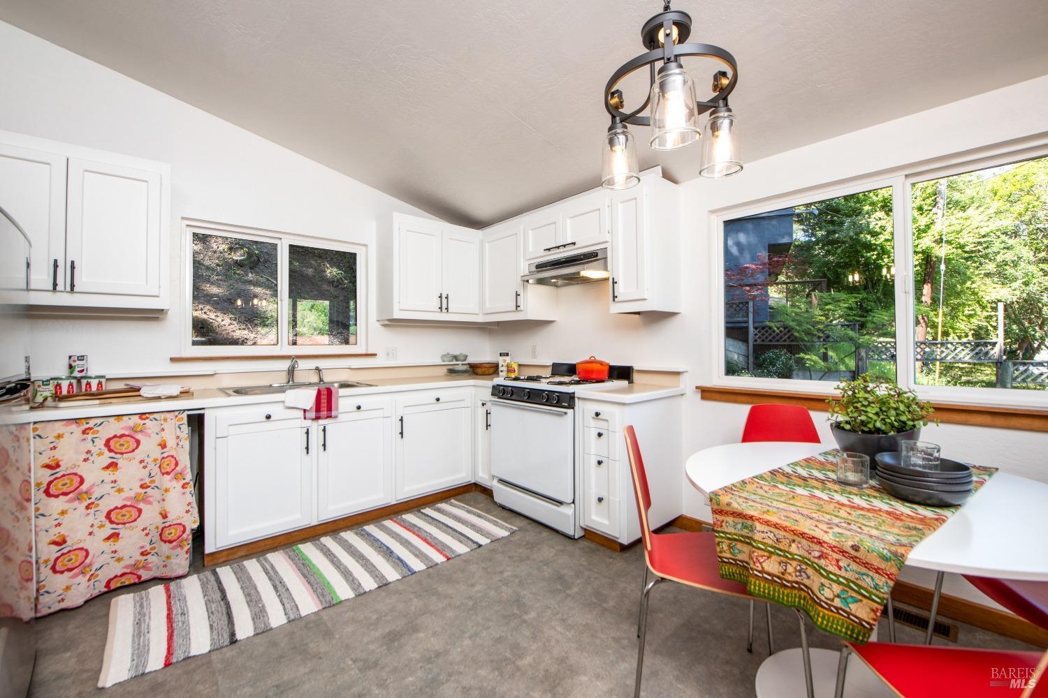 251 West End Avenue San Rafael, CA 94901 - Photo 11 of 35 a open kitchen with stainless steel appliances granite countertop a stove a sink dishwasher and white cabinets with wooden floor