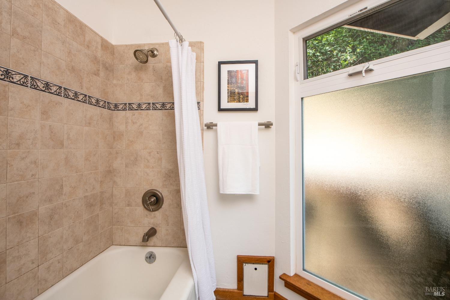 251 West End Avenue San Rafael, CA 94901 - Photo 18 of 35 a bathroom with a shower curtain and a bathtub