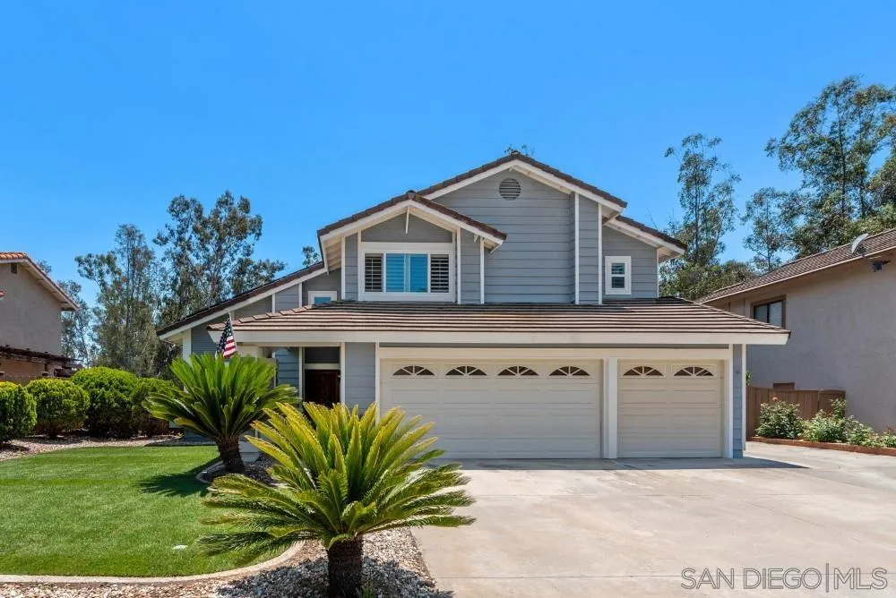 a front view of a house with a garden and plants