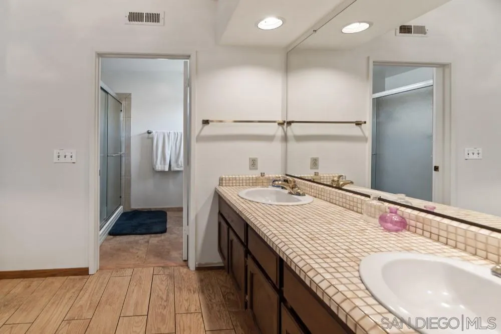13227 Treecrest Street Poway, CA 92064 - Photo 21 of 32 a bathroom with a sink and a mirror