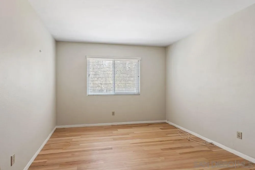 13227 Treecrest Street Poway, CA 92064 - Photo 25 of 32 an empty room with wooden floor and windows