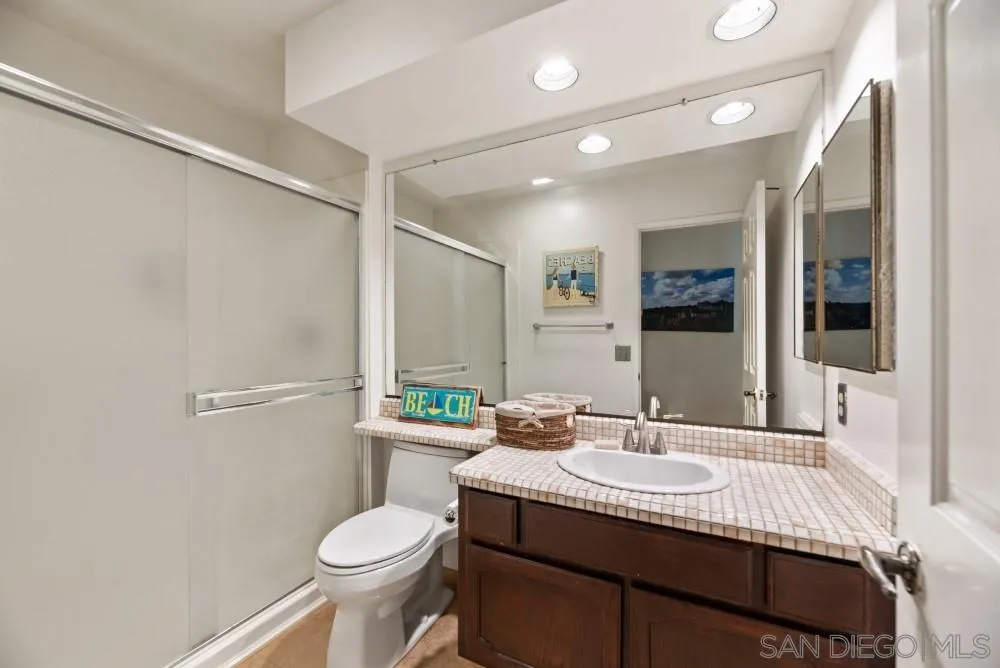 13227 Treecrest Street Poway, CA 92064 - Photo 26 of 32 a bathroom with a granite countertop sink toilet and shower