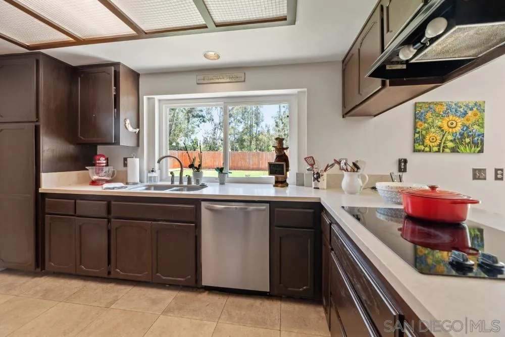 13227 Treecrest Street Poway, CA 92064 - Photo 3 of 32 a kitchen with a sink cabinets and window