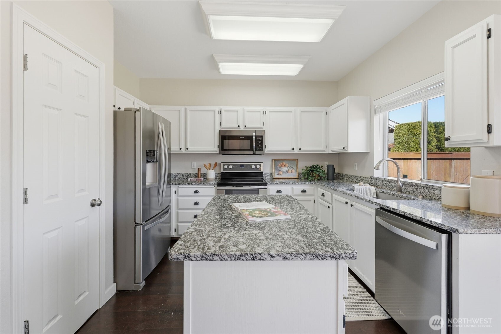 7625 148th Avenue East Sumner, WA 98390 - Photo 12 of 40 a kitchen with granite countertop a refrigerator stove and sink